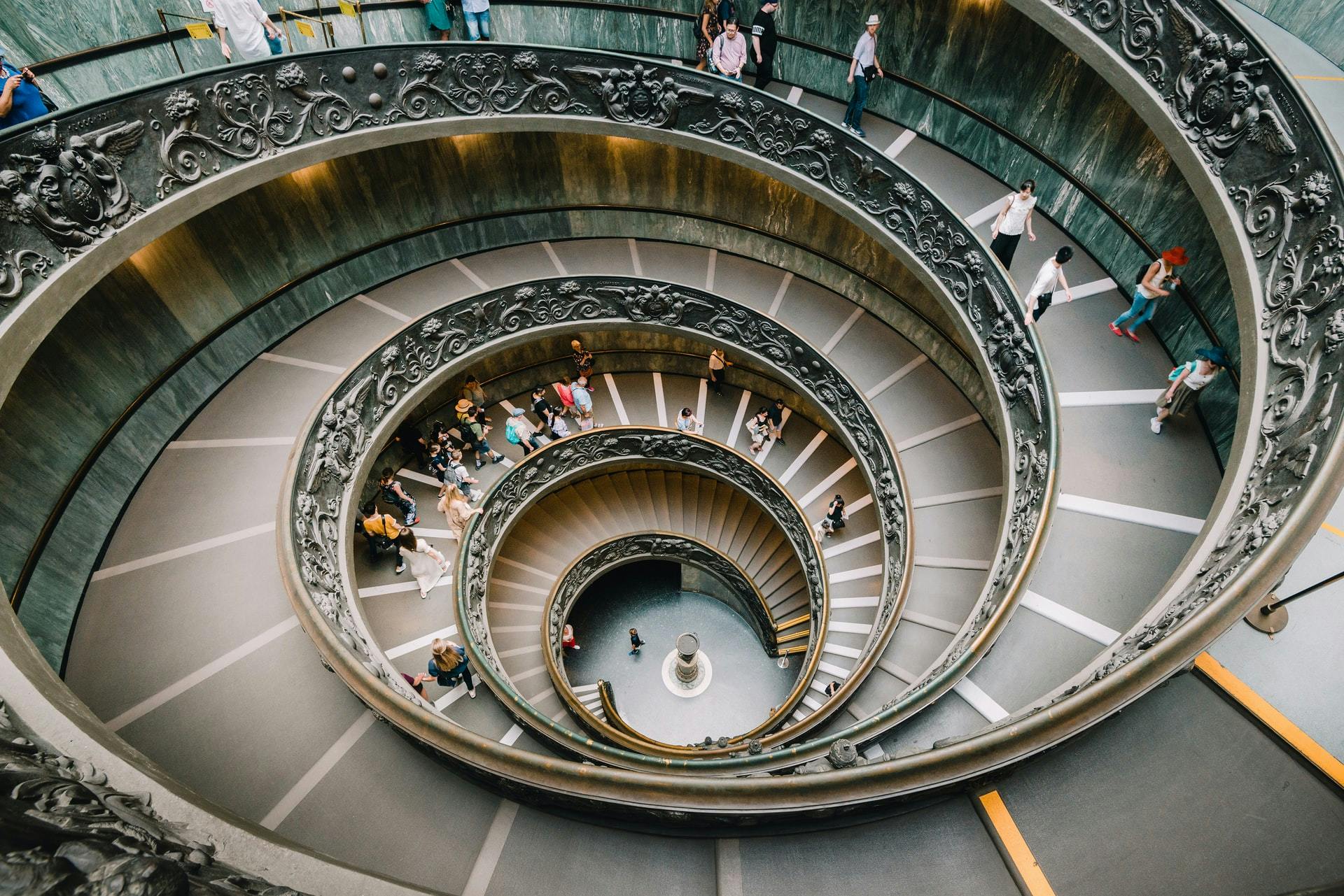 A photo of a staircase from above with people walking on it